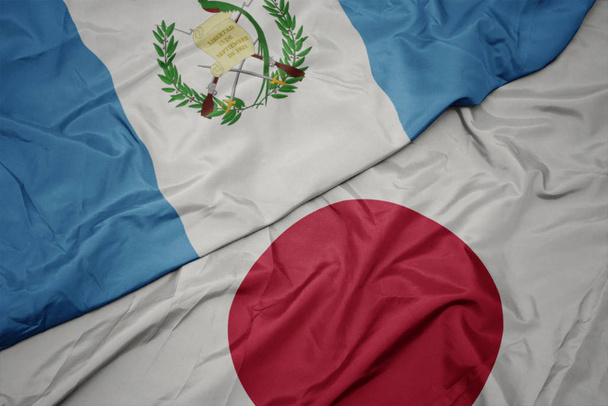 acenando bandeira colorida do japão e bandeira nacional de guatemala
. - Foto, Imagem