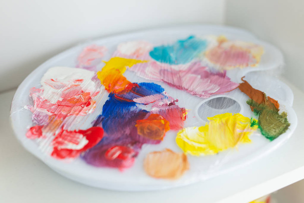 creativity, drawing and hobbies - palette with colorful paints - Photo, Image