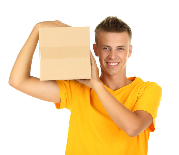 Young delivery man holding parcel, isolated on white - Foto, Bild