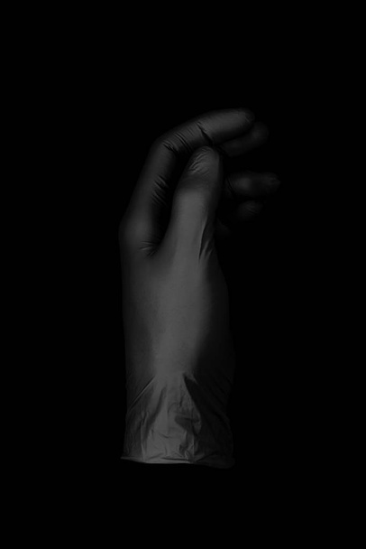 black glove on black background  - Foto, Imagem