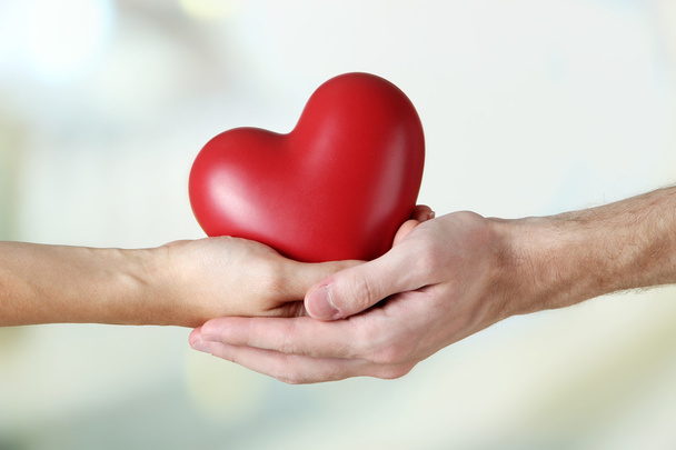 Heart in hands on light background - Foto, immagini