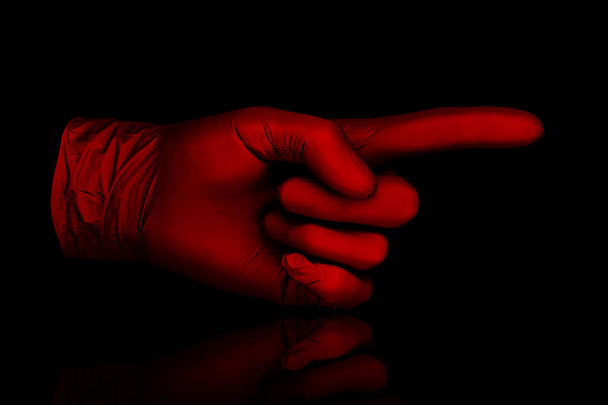 red glove on black background  - Foto, Bild