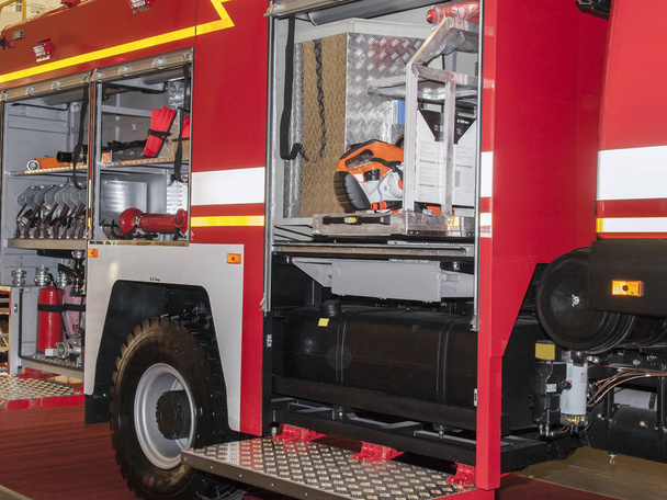 Caminhão de bombeiros aberto com os equipamentos e ferramentas necessários
 - Foto, Imagem