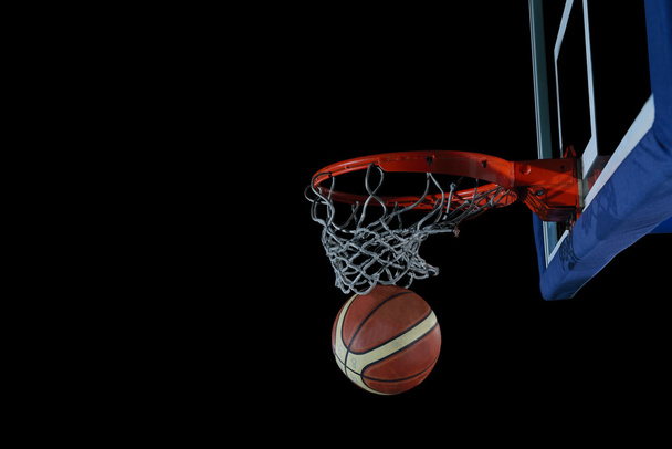 Basketball ball and net on black background - Photo, Image