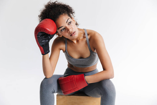 Beautful young amazing sports fitness african woman boxer posing isolated over white background in gloves. - Valokuva, kuva