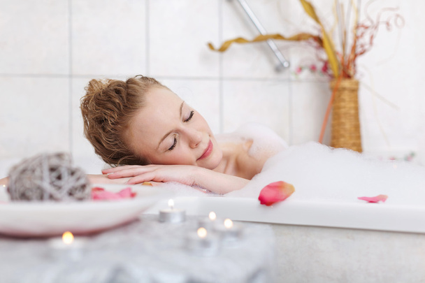 Woman enjoying a stylish atmosphere in her bathtub - Photo, image