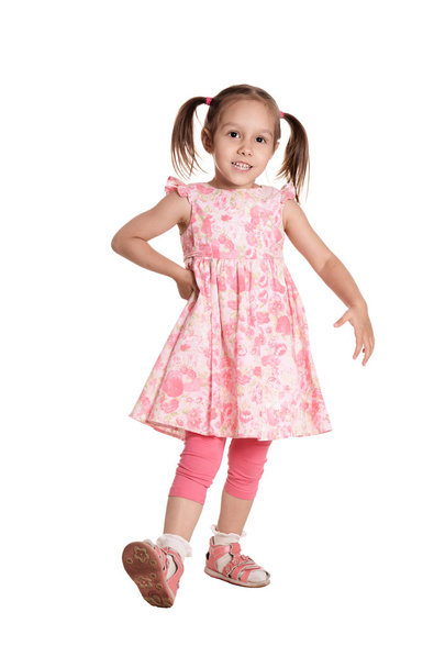 Portrait of a cute little girl in a pink dress - 写真・画像