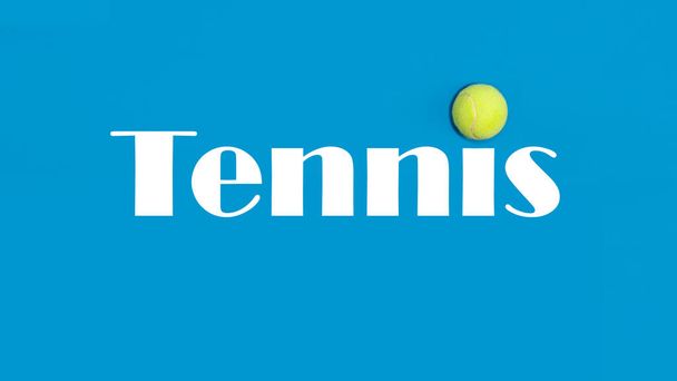 Big tennis ball on blue background - Fotoğraf, Görsel