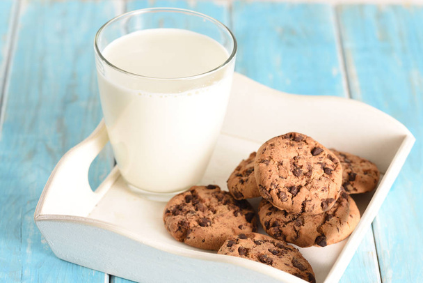 Milk and cookies on the white tray. Biscuit on the turquoise table - Foto, afbeelding