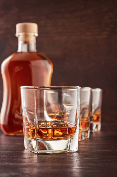 Glass of whiskey on a wooden table - Photo, Image