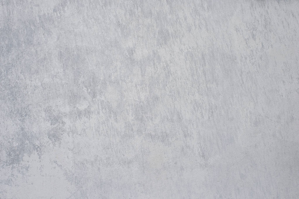 A gray concrete wall interspersed with white plaster. Background - Valokuva, kuva