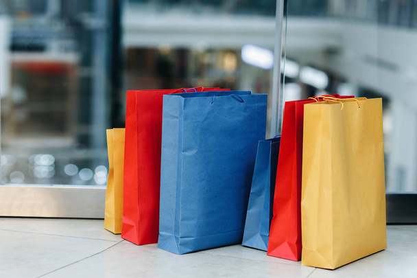 Shopping bags are on the floor of the shopping center. E-commerce digital marketing lifestyle concept. Time for shopping, copy space - Фото, изображение