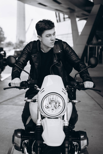 Portrait young guy posing on the motorcycle, fashion men - 写真・画像