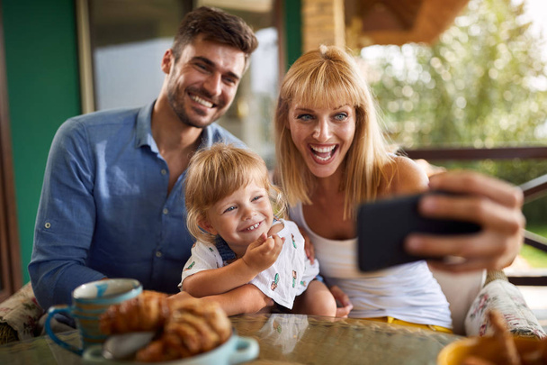 Cheerful family making selfie together  - Zdjęcie, obraz