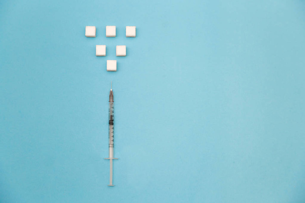 Sugar cubes with syringe. Diabetes concept. - Fotó, kép