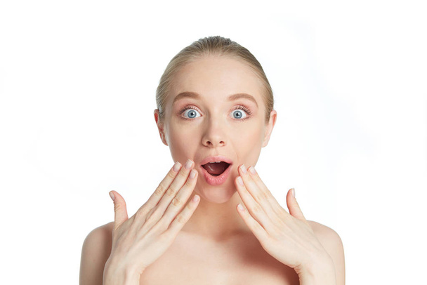 Happy and surprised woman with her hands at face expressing amazement - Photo, Image