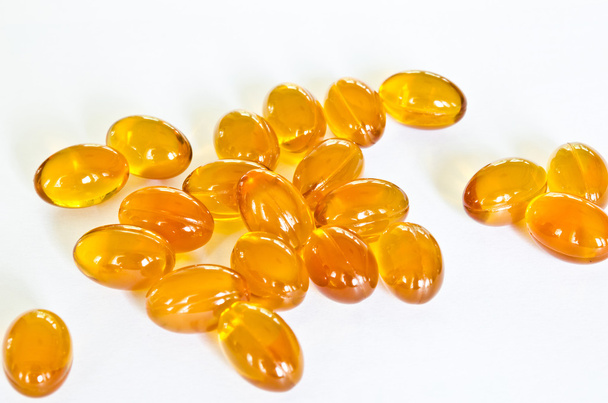 Rice bran oil pills on white background - Foto, afbeelding