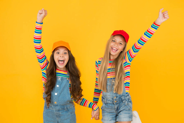Happy smiling girls sisters best friends. True friendship. Carefree and happy childhood. Happy childrens day. Family look. Friendly and happy children. Stylish children. International childrens day - Fotoğraf, Görsel