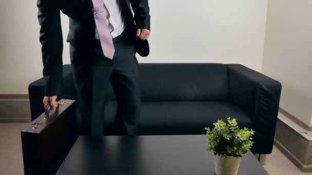 A businessman has legs on the table - Footage, Video