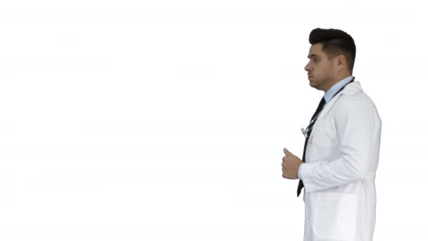 Walking male doctor passing by on white background. - Felvétel, videó