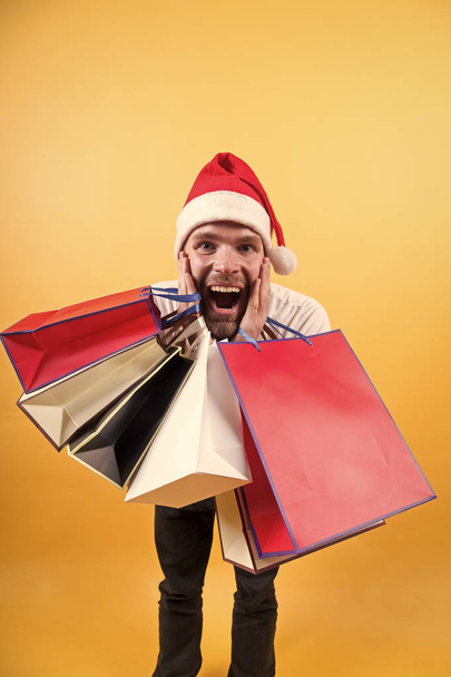 online christmas shopping. Happy new year. man in santa hat hold christmas present. happy santa man on yellow wall. The morning before Xmas. delivery christmas gifts. Merry Christmas. look at this - Fotoğraf, Görsel