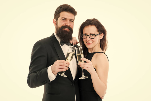 Cheers concept. Couple classy clothes drink champagne white background. Man bearded wear tuxedo girl elegant celebrate anniversary. Holiday celbration. Party celebration. Official celebration event - Foto, afbeelding
