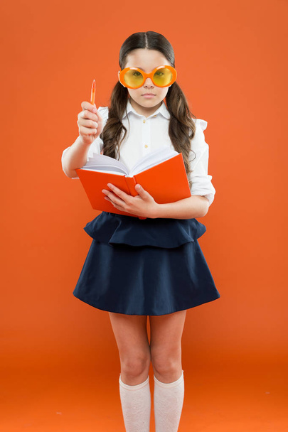 inspiration for writing. get information from book. happy school girl in uniform and party glasses. small child with notebook. literature lesson education. writing in workbook. children literature - Photo, image