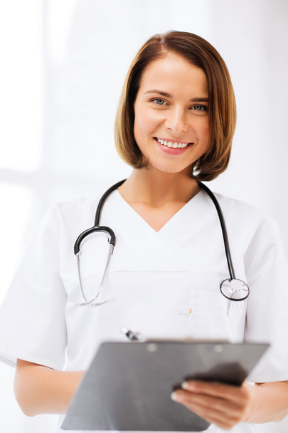 Doctor with stethoscope writing prescription - Foto, imagen