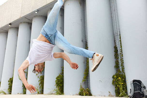 dancer doing a movement, man falling down while performing a flip - Photo, Image