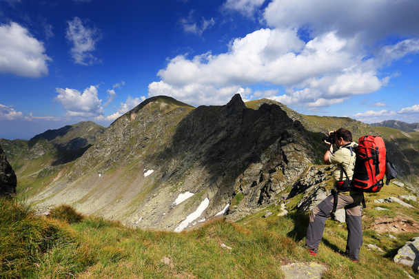 Nature photographer taking photos in the mountains - Foto, imagen