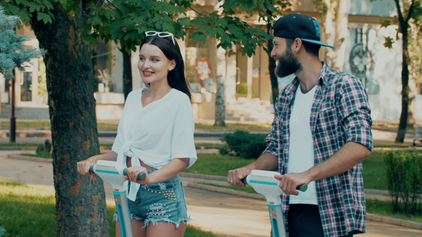 Couple ridding segway and smiling - Materiał filmowy, wideo