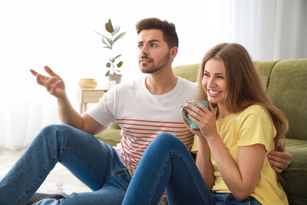 Happy couple watching TV at home - Photo, Image