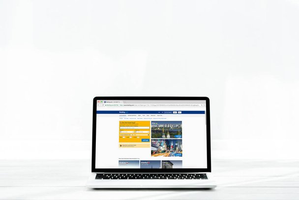 KYIV, UKRAINE - JULY 23, 2019: modern laptop with booking website on screen on white  - Zdjęcie, obraz