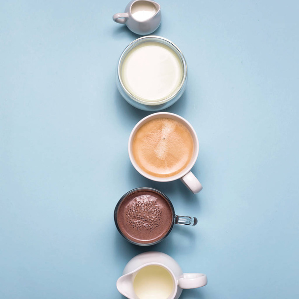 Coffee, cocoa and matcha with white creamers of milk on blue - Photo, Image