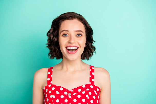 Close up portrait of overjoyed rejoicing gorgeous funny funky charming girlfriend who cannot help admiring handsome guy passing by her while isolated with teal background - 写真・画像