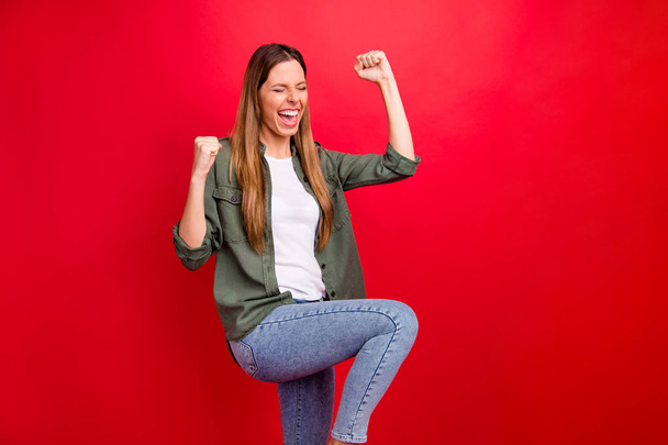 Photo of rejoicing overjoyed girl having learned about her having entered some university while isolated with red background - Photo, Image