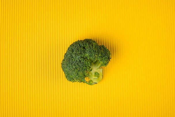 Broccoli on yellow background - Φωτογραφία, εικόνα