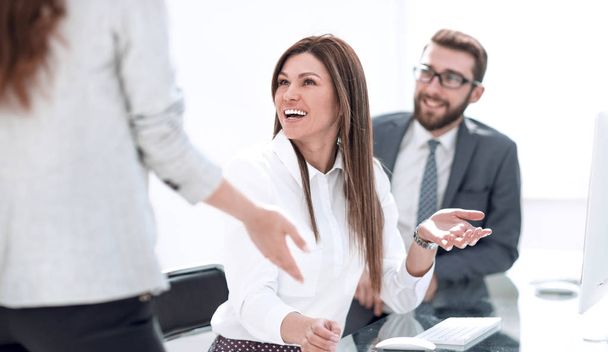smiling employees talking in the workplace. - Valokuva, kuva