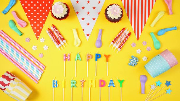 Colorful birthday party flat lay on yellow background. - Foto, afbeelding