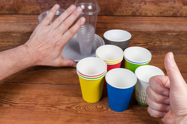 Gestures approving use disposable paper cups and renounce plastic tableware - Photo, Image
