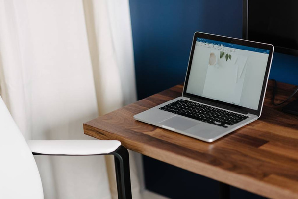 A shot of a laptop on a wooden desk - Zdjęcie, obraz