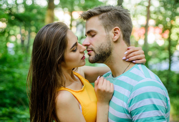 Giving kiss. Seduction and foreplay. Sensual kiss of lovely couple close up. Couple in love kissing with passion outdoors. Man and woman attractive lovers romantic kiss. Passionate kiss concept - Фото, зображення