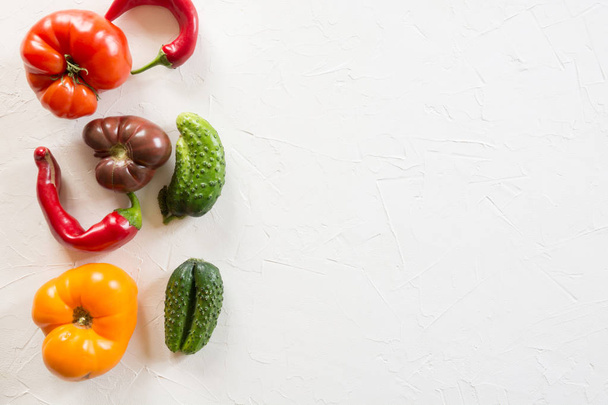 Ugly organic colorful tomato, pepper, cucumber on white. - Valokuva, kuva