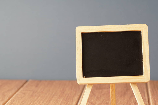 small chalkboard on wooden table, copy space concept - Foto, Imagen