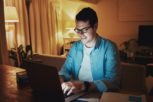 Happy male freelancer enjoying working on laptop at home - Фото, зображення