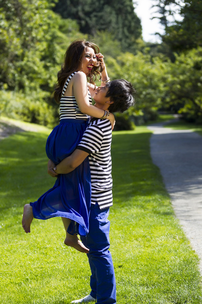 Young Adult Couple Playing Around while Walking Outdoors - Photo, Image