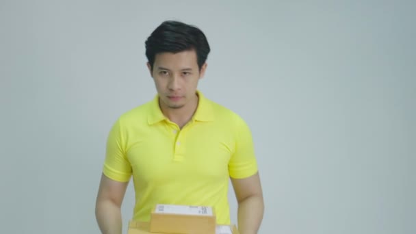 Dostawa, poczta, wysyłka i koncepcja ludzi-młody Asian Mężczyzna dając paczki pudełko - Materiał filmowy, wideo
