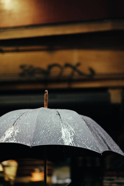 Wet black stained umbrella after rain - Valokuva, kuva