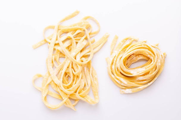 Top view of home made pasta on white background - Foto, Imagen