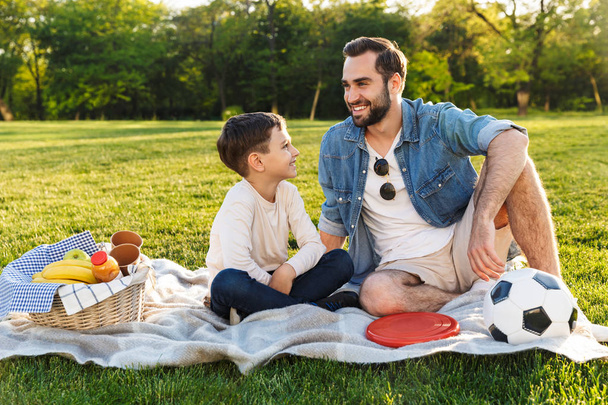 Happy young father having a picnic with his little son - Photo, Image
